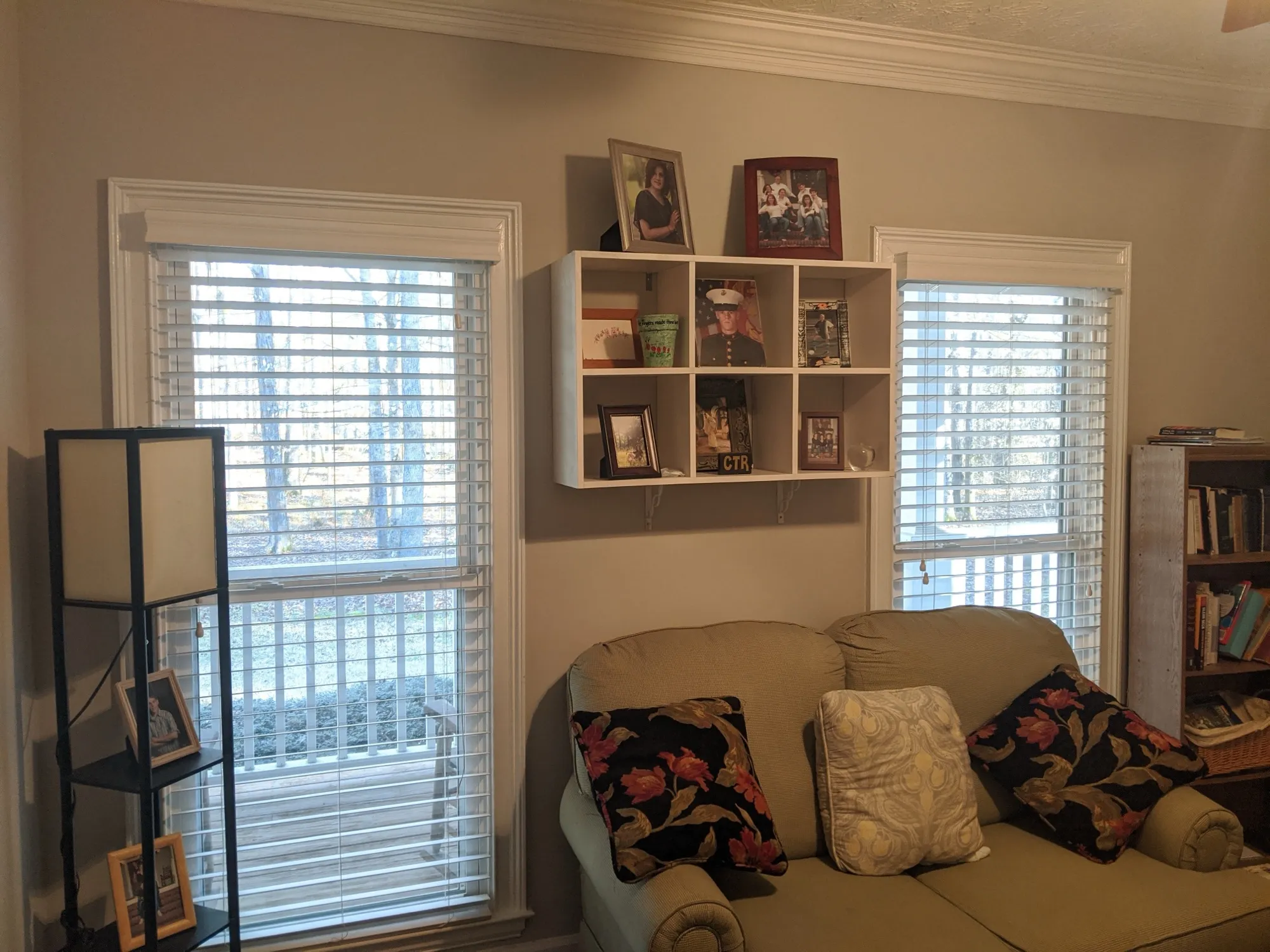 White 2.5-inch faux wood blinds with matching valances on two family room windows.